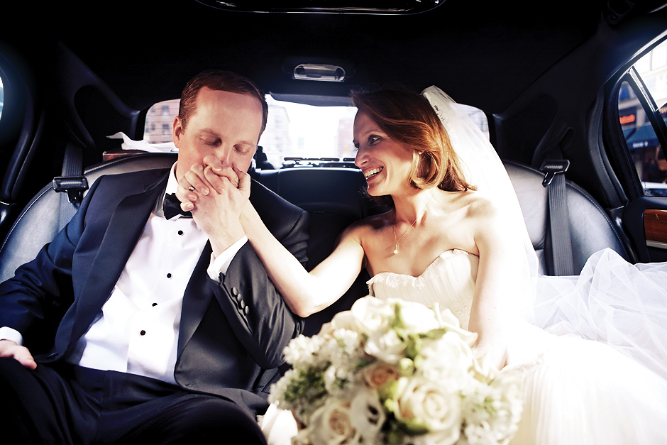 The bride and groom share a moment in the limo following their wedding ceremony in New York City